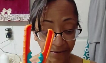 Tonya holding a Yewtwist up beside her face